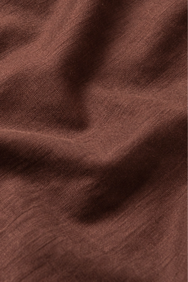 T-shirt Shape Monika Kaminska – 100% wełna merino z certyfikatem Woolmark. Zbliżenie na fakturę tkaniny w kolorze brązowym.